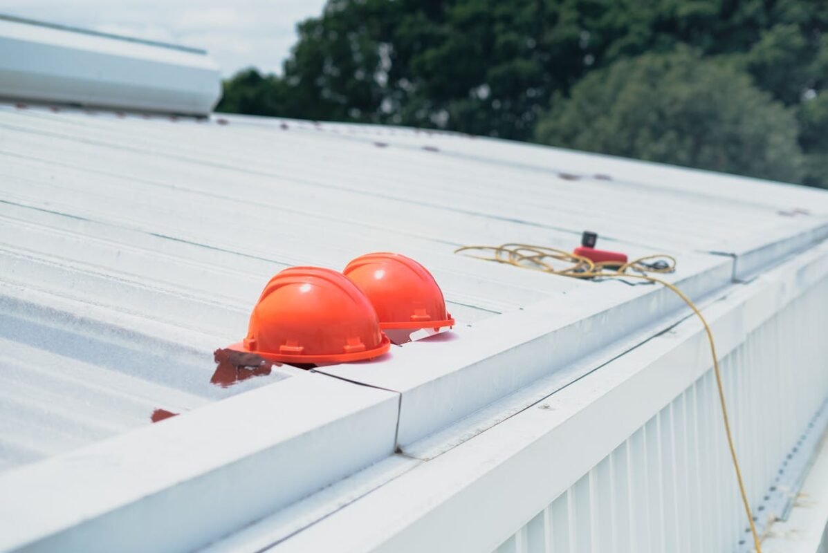 Best commercial roofer on a commercial roof with safety helmets.