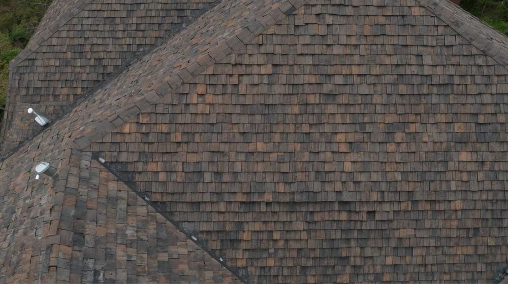 Aerial view of a wood shake roof with natural textures, highlighting the rustic appearance in the Wood Shake vs Wood Shingle comparison.