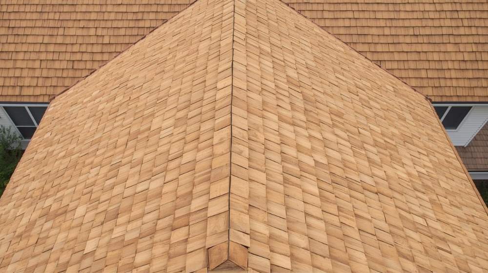 Clean and polished wood shingle roof, offering a refined and uniform appearance in the Wood Shake vs Wood Shingle comparison .